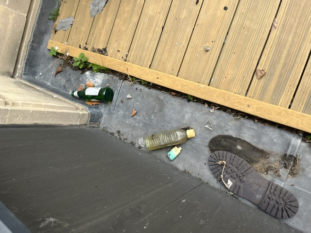Debris and concealment points inspected beside exterior decking in central Bristol
